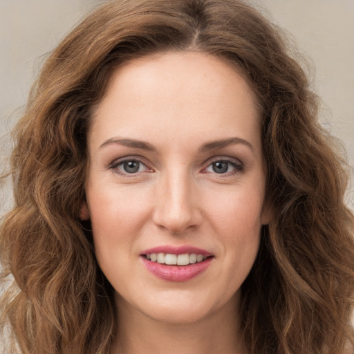 Joyful white young-adult female with long  brown hair and green eyes