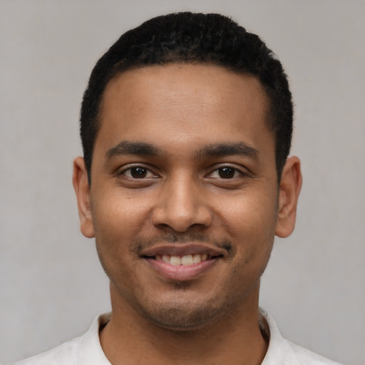 Joyful latino young-adult male with short  black hair and brown eyes