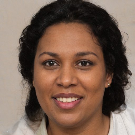 Joyful white adult female with medium  brown hair and brown eyes