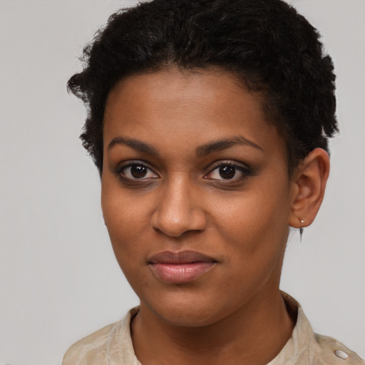 Joyful black young-adult female with short  brown hair and brown eyes