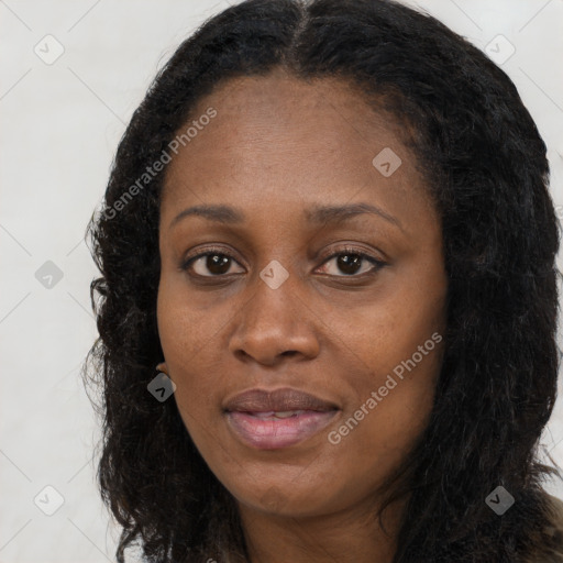 Joyful black young-adult female with long  black hair and brown eyes