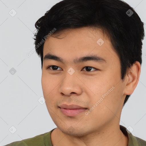 Joyful asian young-adult male with short  black hair and brown eyes