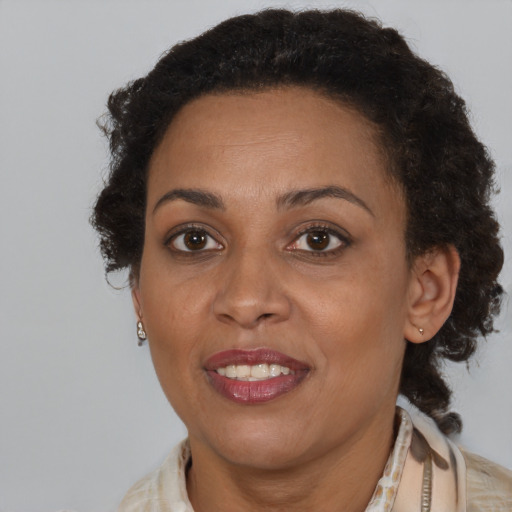 Joyful black adult female with short  brown hair and brown eyes