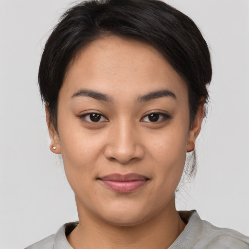 Joyful asian young-adult female with short  black hair and brown eyes