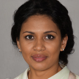 Joyful black adult female with short  brown hair and brown eyes