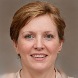 Joyful white adult female with medium  brown hair and grey eyes