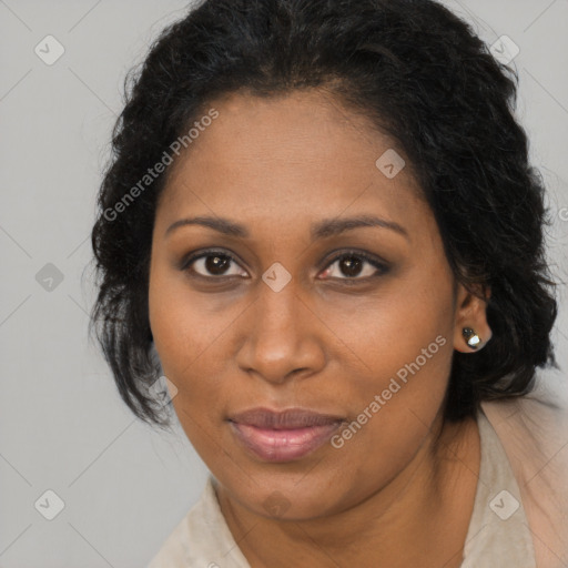 Joyful black young-adult female with long  brown hair and brown eyes