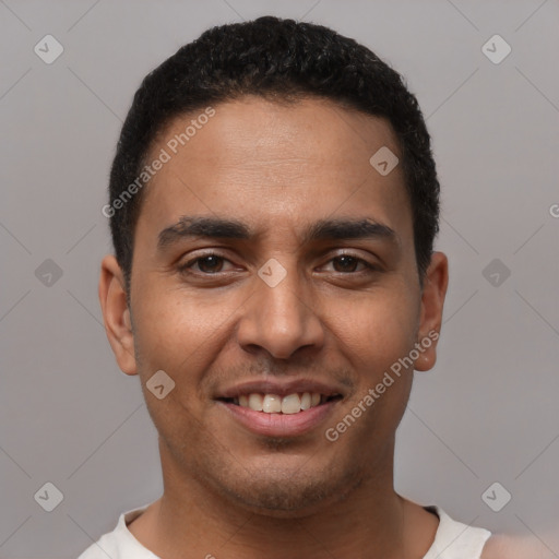 Joyful latino young-adult male with short  black hair and brown eyes