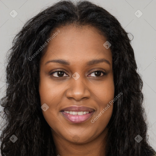 Joyful black young-adult female with long  brown hair and brown eyes