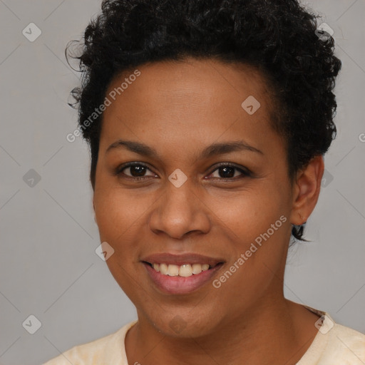 Joyful black young-adult female with short  brown hair and brown eyes