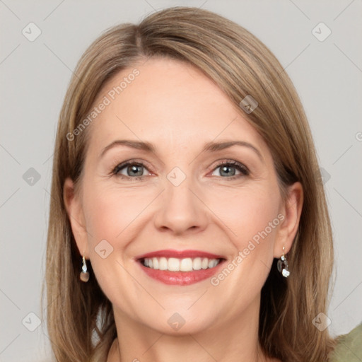 Joyful white adult female with long  brown hair and grey eyes