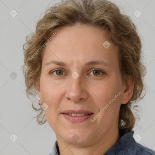 Joyful white adult female with medium  brown hair and blue eyes