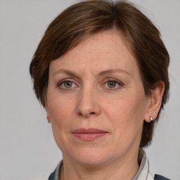 Joyful white adult female with medium  brown hair and grey eyes