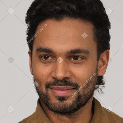 Joyful black young-adult male with short  black hair and brown eyes