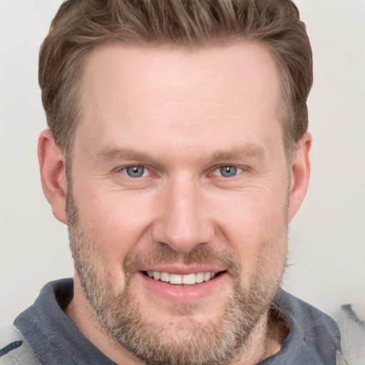 Joyful white adult male with short  brown hair and grey eyes