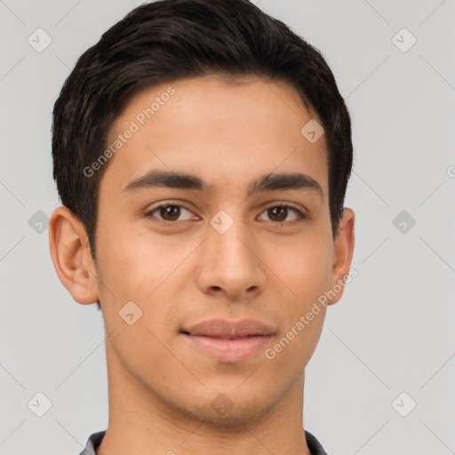 Joyful latino young-adult male with short  brown hair and brown eyes