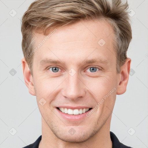 Joyful white young-adult male with short  brown hair and grey eyes