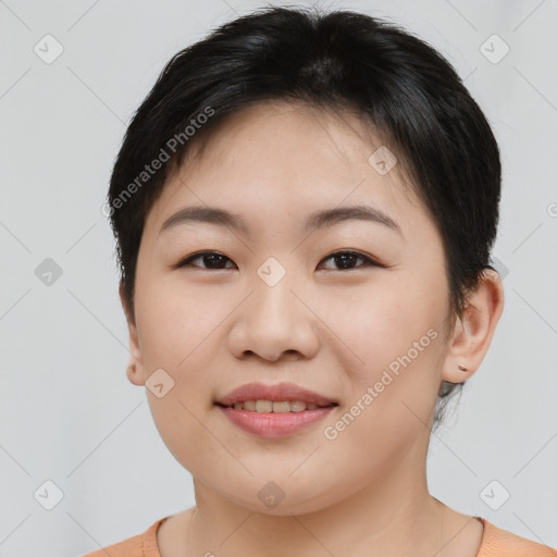 Joyful asian young-adult female with short  brown hair and brown eyes