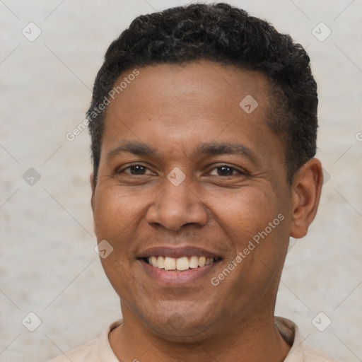 Joyful latino adult male with short  brown hair and brown eyes