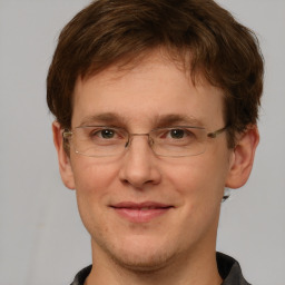 Joyful white adult male with short  brown hair and grey eyes