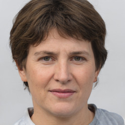 Joyful white adult female with short  brown hair and brown eyes