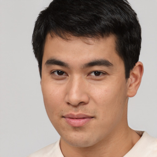 Joyful white young-adult male with short  black hair and brown eyes