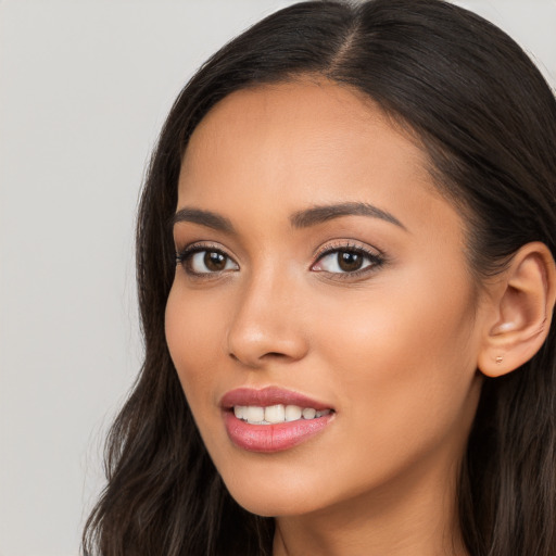 Joyful latino young-adult female with long  brown hair and brown eyes