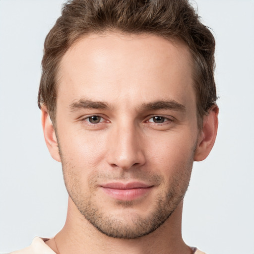 Joyful white young-adult male with short  brown hair and grey eyes