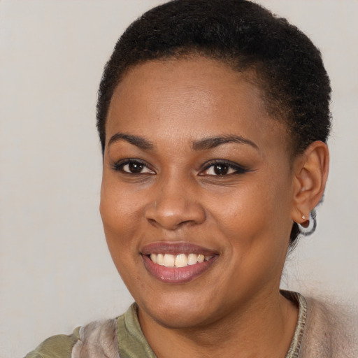Joyful black young-adult female with short  brown hair and brown eyes