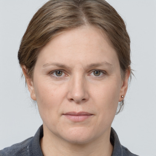 Joyful white adult female with medium  brown hair and grey eyes