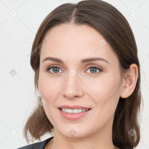 Joyful white young-adult female with medium  brown hair and grey eyes