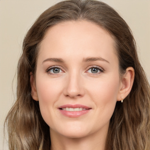 Joyful white young-adult female with long  brown hair and grey eyes