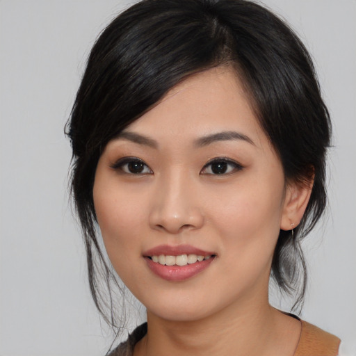 Joyful asian young-adult female with medium  black hair and brown eyes