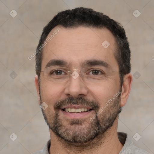 Joyful white adult male with short  black hair and brown eyes