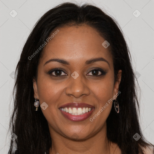 Joyful black young-adult female with long  brown hair and brown eyes