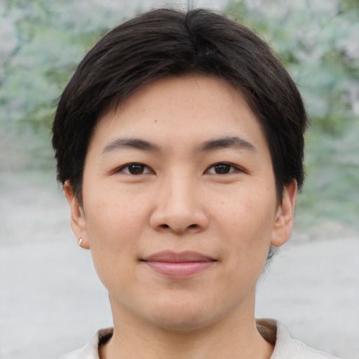 Joyful asian young-adult male with short  brown hair and brown eyes