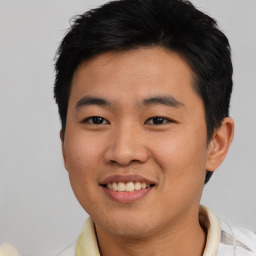 Joyful asian young-adult male with short  brown hair and brown eyes