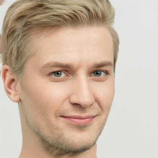 Joyful white adult male with short  brown hair and green eyes