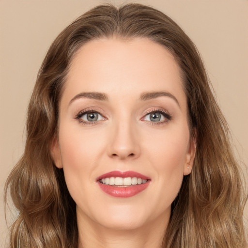 Joyful white young-adult female with long  brown hair and green eyes