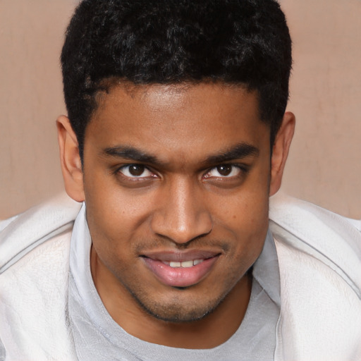 Joyful black young-adult male with short  brown hair and brown eyes