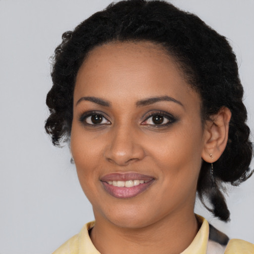 Joyful black young-adult female with medium  black hair and brown eyes
