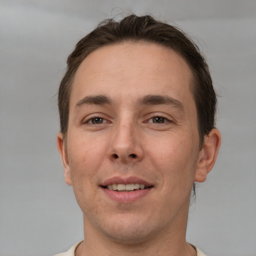 Joyful white young-adult male with short  brown hair and brown eyes