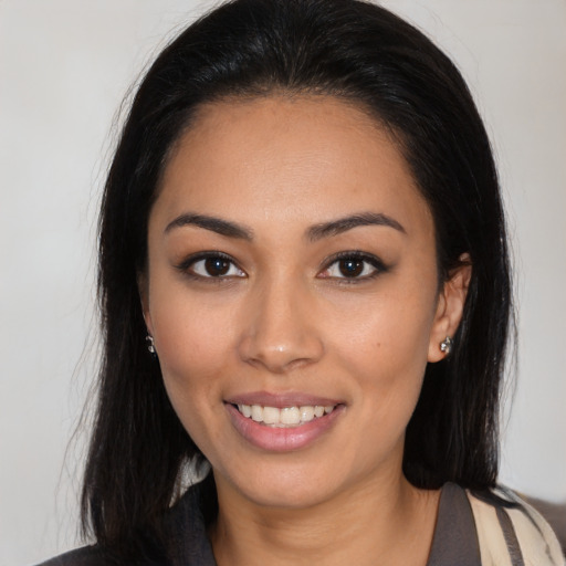 Joyful latino young-adult female with long  black hair and brown eyes