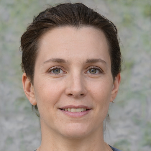 Joyful white adult female with short  brown hair and grey eyes