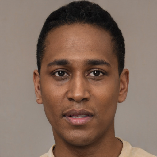 Joyful black young-adult male with short  black hair and brown eyes