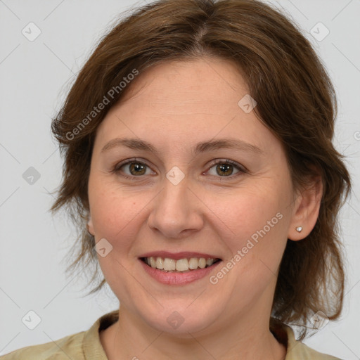 Joyful white young-adult female with medium  brown hair and green eyes