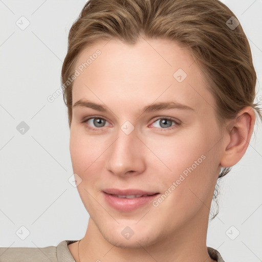 Joyful white young-adult female with short  brown hair and grey eyes