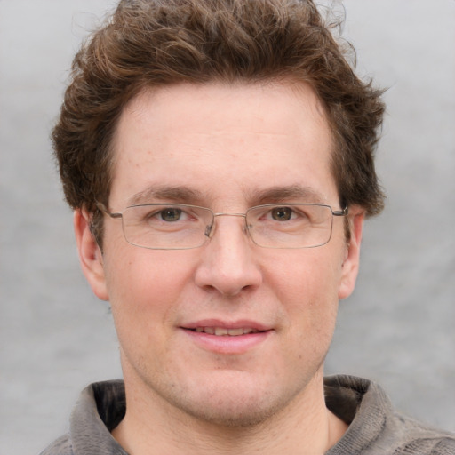 Joyful white adult male with short  brown hair and grey eyes