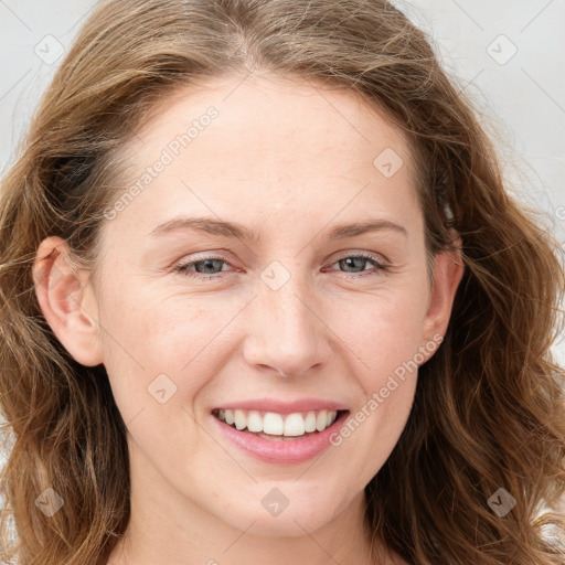 Joyful white young-adult female with long  brown hair and blue eyes