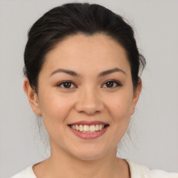 Joyful latino young-adult female with medium  brown hair and brown eyes